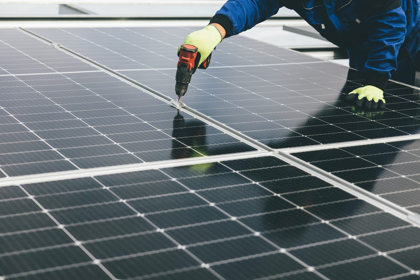 Installer securing solar panels during a rooftop solar installation
